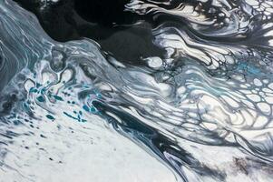 Abstract created using the technique of liquid acrylic. Macro photography of the smallest details of a picture. The picture shows how overflows of shades and colors of paint resemble space motifs. photo