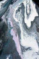 Abstract created using the technique of liquid acrylic. Macro photography of the smallest details of a picture. The picture shows how overflows of shades and colors of paint resemble space motifs. photo