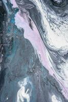 Abstract created using the technique of liquid acrylic. Macro photography of the smallest details of a picture. The picture shows how overflows of shades and colors of paint resemble space motifs. photo