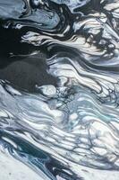 Abstract created using the technique of liquid acrylic. Macro photography of the smallest details of a picture. The picture shows how overflows of shades and colors of paint resemble space motifs. photo