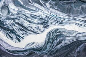 Abstract created using the technique of liquid acrylic. Macro photography of the smallest details of a picture. The picture shows how overflows of shades and colors of paint resemble space motifs. photo