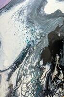 Abstract created using the technique of liquid acrylic. Macro photography of the smallest details of a picture. The picture shows how overflows of shades and colors of paint resemble space motifs. photo