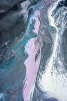 Abstract created using the technique of liquid acrylic. Macro photography of the smallest details of a picture. The picture shows how overflows of shades and colors of paint resemble space motifs. photo