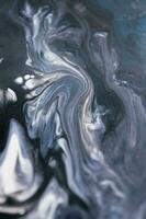 Abstract created using the technique of liquid acrylic. Macro photography of the smallest details of a picture. The picture shows how overflows of shades and colors of paint resemble space motifs. photo