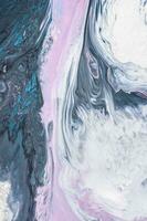 Abstract created using the technique of liquid acrylic. Macro photography of the smallest details of a picture. The picture shows how overflows of shades and colors of paint resemble space motifs. photo