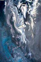 Abstract created using the technique of liquid acrylic. Macro photography of the smallest details of a picture. The picture shows how overflows of shades and colors of paint resemble space motifs. photo