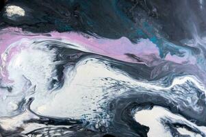 Abstract created using the technique of liquid acrylic. Macro photography of the smallest details of a picture. The picture shows how overflows of shades and colors of paint resemble space motifs. photo