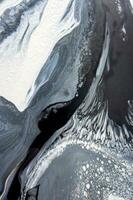 Abstract created using the technique of liquid acrylic. Macro photography of the smallest details of a picture. The picture shows how overflows of shades and colors of paint resemble space motifs. photo