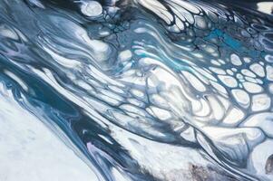 Abstract created using the technique of liquid acrylic. Macro photography of the smallest details of a picture. The picture shows how overflows of shades and colors of paint resemble space motifs. photo