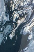 Abstract created using the technique of liquid acrylic. Macro photography of the smallest details of a picture. The picture shows how overflows of shades and colors of paint resemble space motifs. photo