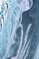 Abstract created using the technique of liquid acrylic. Macro photography of the smallest details of a picture. The picture shows how overflows of shades and colors of paint resemble space motifs. photo