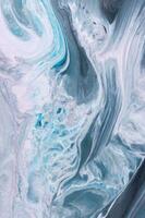 Abstract created using the technique of liquid acrylic. Macro photography of the smallest details of a picture. The picture shows how overflows of shades and colors of paint resemble space motifs. photo