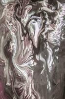 Abstract created using the technique of liquid acrylic. Macro photography of the smallest details of a picture. The picture shows how overflows of shades and colors of paint resemble space motifs. photo