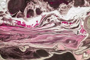 Abstract created using the technique of liquid acrylic. Macro photography of the smallest details of a picture. The picture shows how overflows of shades and colors of paint resemble space motifs. photo