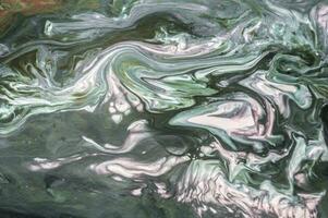 Abstract created using the technique of liquid acrylic. Macro photography of the smallest details of a picture. The picture shows how overflows of shades and colors of paint resemble space motifs. photo