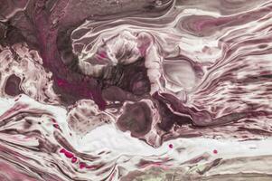 Abstract created using the technique of liquid acrylic. Macro photography of the smallest details of a picture. The picture shows how overflows of shades and colors of paint resemble space motifs. photo