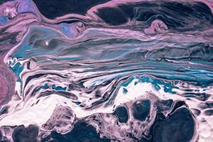Abstract created using the technique of liquid acrylic. Macro photography of the smallest details of a picture. The picture shows how overflows of shades and colors of paint resemble space motifs. photo