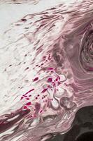 Abstract created using the technique of liquid acrylic. Macro photography of the smallest details of a picture. The picture shows how overflows of shades and colors of paint resemble space motifs. photo