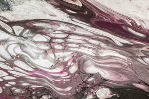 Abstract created using the technique of liquid acrylic. Macro photography of the smallest details of a picture. The picture shows how overflows of shades and colors of paint resemble space motifs. photo