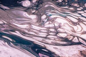 Abstract created using the technique of liquid acrylic. Macro photography of the smallest details of a picture. The picture shows how overflows of shades and colors of paint resemble space motifs. photo