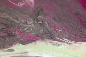 Abstract created using the technique of liquid acrylic. Macro photography of the smallest details of a picture. The picture shows how overflows of shades and colors of paint resemble space motifs. photo