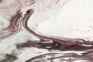 Abstract created using the technique of liquid acrylic. Macro photography of the smallest details of a picture. The picture shows how overflows of shades and colors of paint resemble space motifs. photo