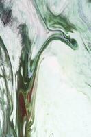 Abstract created using the technique of liquid acrylic. Macro photography of the smallest details of a picture. The picture shows how overflows of shades and colors of paint resemble space motifs. photo