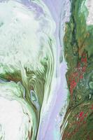 Abstract created using the technique of liquid acrylic. Macro photography of the smallest details of a picture. The picture shows how overflows of shades and colors of paint resemble space motifs. photo