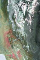 Abstract created using the technique of liquid acrylic. Macro photography of the smallest details of a picture. The picture shows how overflows of shades and colors of paint resemble space motifs. photo