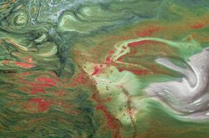 Abstract created using the technique of liquid acrylic. Macro photography of the smallest details of a picture. The picture shows how overflows of shades and colors of paint resemble space motifs. photo
