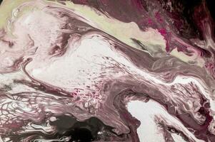 Abstract created using the technique of liquid acrylic. Macro photography of the smallest details of a picture. The picture shows how overflows of shades and colors of paint resemble space motifs. photo