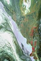 Abstract created using the technique of liquid acrylic. Macro photography of the smallest details of a picture. The picture shows how overflows of shades and colors of paint resemble space motifs. photo