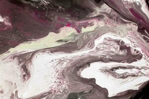 Abstract created using the technique of liquid acrylic. Macro photography of the smallest details of a picture. The picture shows how overflows of shades and colors of paint resemble space motifs. photo