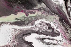 Abstract created using the technique of liquid acrylic. Macro photography of the smallest details of a picture. The picture shows how overflows of shades and colors of paint resemble space motifs. photo