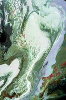 Abstract created using the technique of liquid acrylic. Macro photography of the smallest details of a picture. The picture shows how overflows of shades and colors of paint resemble space motifs. photo