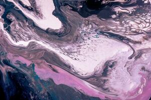 Abstract created using the technique of liquid acrylic. Macro photography of the smallest details of a picture. The picture shows how overflows of shades and colors of paint resemble space motifs. photo