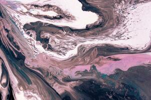 Abstract created using the technique of liquid acrylic. Macro photography of the smallest details of a picture. The picture shows how overflows of shades and colors of paint resemble space motifs. photo