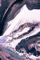 Abstract created using the technique of liquid acrylic. Macro photography of the smallest details of a picture. The picture shows how overflows of shades and colors of paint resemble space motifs. photo
