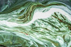 Abstract created using the technique of liquid acrylic. Macro photography of the smallest details of a picture. The picture shows how overflows of shades and colors of paint resemble space motifs. photo