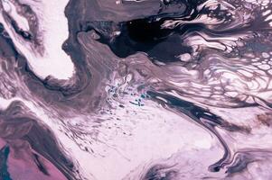 Abstract created using the technique of liquid acrylic. Macro photography of the smallest details of a picture. The picture shows how overflows of shades and colors of paint resemble space motifs. photo