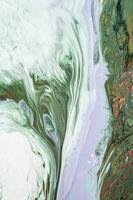 Abstract created using the technique of liquid acrylic. Macro photography of the smallest details of a picture. The picture shows how overflows of shades and colors of paint resemble space motifs. photo