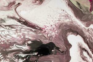 Abstract created using the technique of liquid acrylic. Macro photography of the smallest details of a picture. The picture shows how overflows of shades and colors of paint resemble space motifs. photo