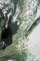 Abstract created using the technique of liquid acrylic. Macro photography of the smallest details of a picture. The picture shows how overflows of shades and colors of paint resemble space motifs. photo