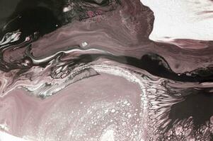 Abstract created using the technique of liquid acrylic. Macro photography of the smallest details of a picture. The picture shows how overflows of shades and colors of paint resemble space motifs. photo