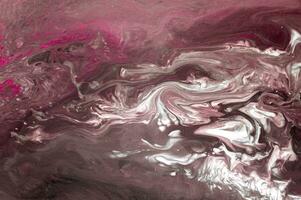 Abstract created using the technique of liquid acrylic. Macro photography of the smallest details of a picture. The picture shows how overflows of shades and colors of paint resemble space motifs. photo