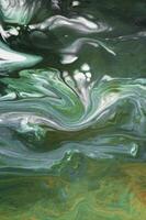 Abstract created using the technique of liquid acrylic. Macro photography of the smallest details of a picture. The picture shows how overflows of shades and colors of paint resemble space motifs. photo