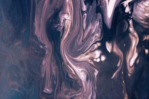 Abstract created using the technique of liquid acrylic. Macro photography of the smallest details of a picture. The picture shows how overflows of shades and colors of paint resemble space motifs. photo