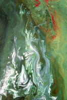 Abstract created using the technique of liquid acrylic. Macro photography of the smallest details of a picture. The picture shows how overflows of shades and colors of paint resemble space motifs. photo
