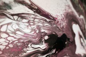 Abstract created using the technique of liquid acrylic. Macro photography of the smallest details of a picture. The picture shows how overflows of shades and colors of paint resemble space motifs. photo