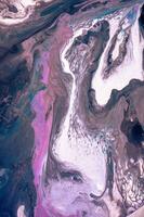 Abstract created using the technique of liquid acrylic. Macro photography of the smallest details of a picture. The picture shows how overflows of shades and colors of paint resemble space motifs. photo